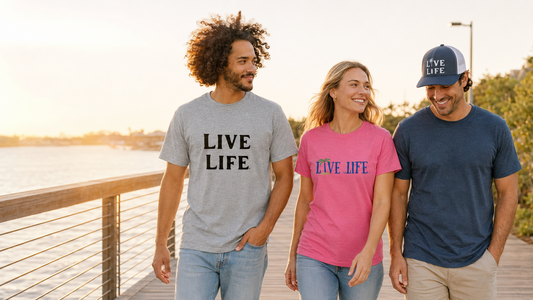 Friends wearing actual LIVE LIFE® shirts and snapback cap on a waterfront boardwalk