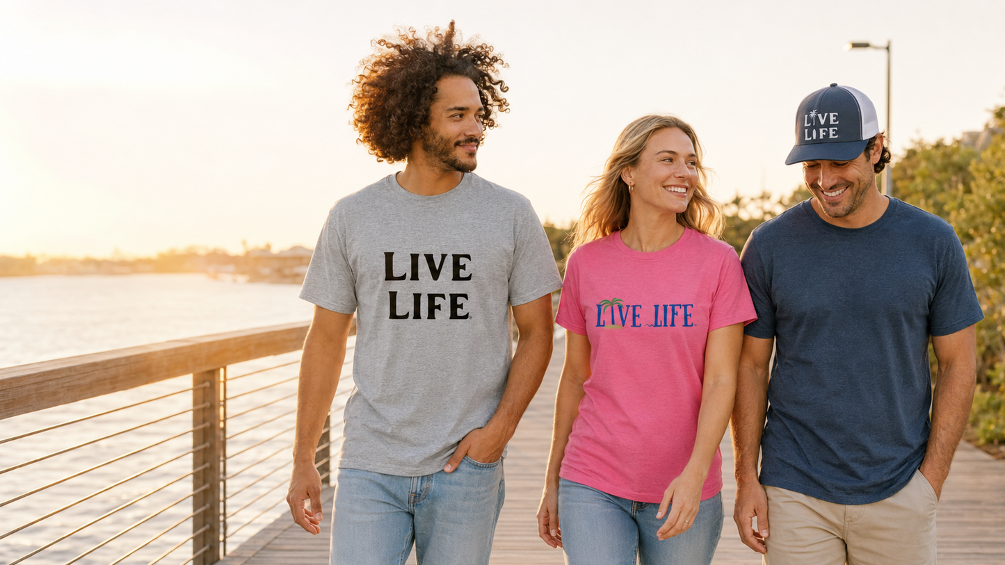 Friends wearing actual LIVE LIFE® shirts and snapback cap on a waterfront boardwalk