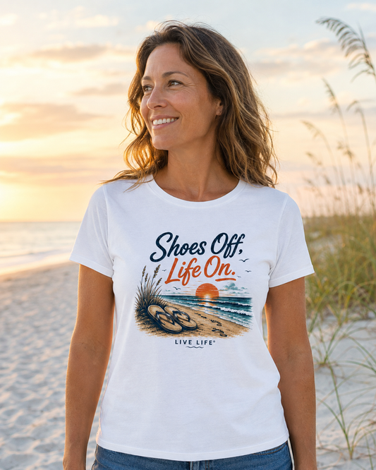 Woman wearing the Shoes Off. Life On. women’s tee on a Florida Gulf Coast beach at sunset